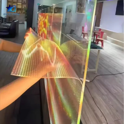 Person holding a flexible, colorful LED display in an indoor setting