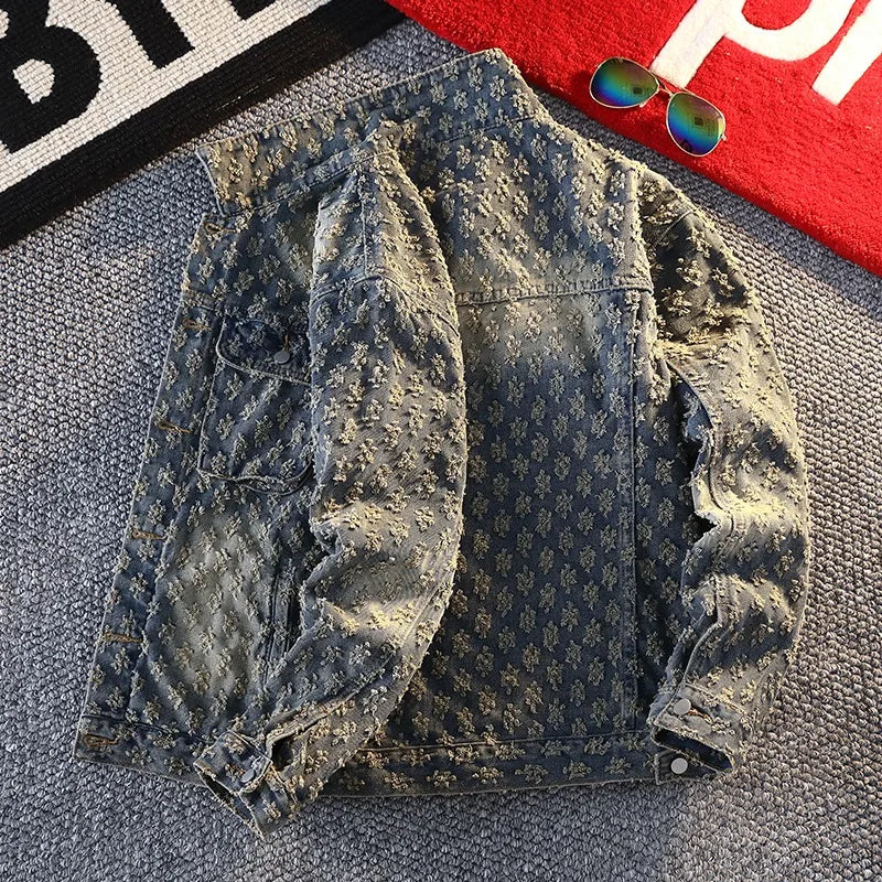 Distressed denim jacket on a textured surface with sunglasses in the background