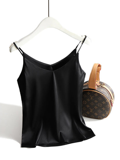 Black satin camisole on a hanger with a Louis Vuitton handbag in the background
