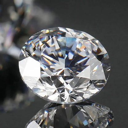 Close-up of a clear diamond on a reflective surface with a blurred background