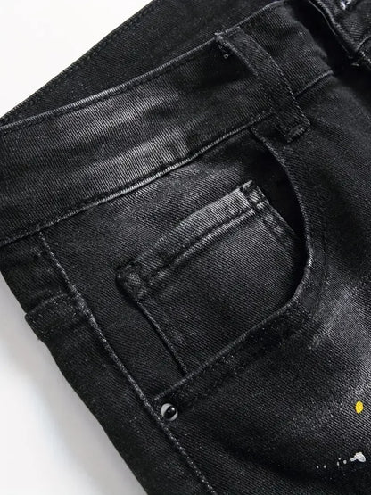 Close-up of black jeans with a brand logo on a white background