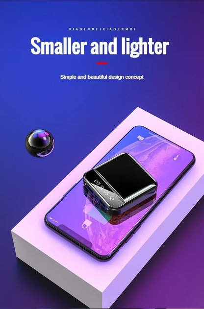 Smartphone with a small black device on a purple and white background
