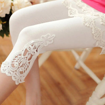 White lace-trimmed tights worn by a person sitting on a chair.