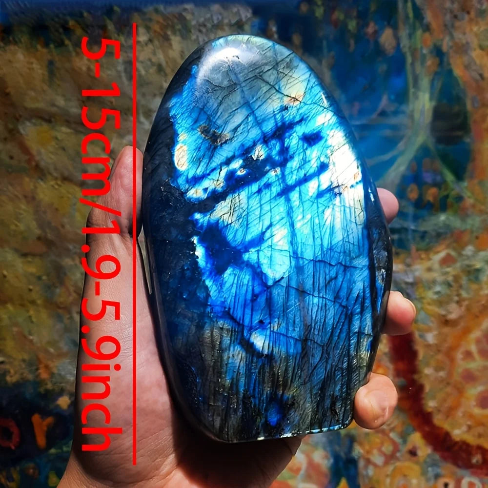Blue labradorite stone held in a hand with measurement text on a colorful background
