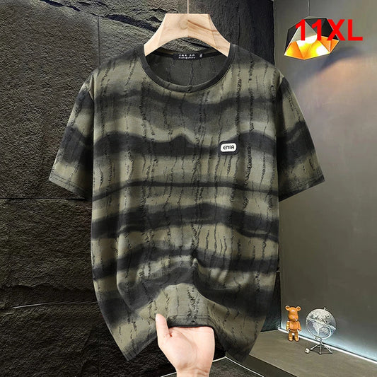 Black and gray tie-dye t-shirt on a hanger against a dark textured wall.