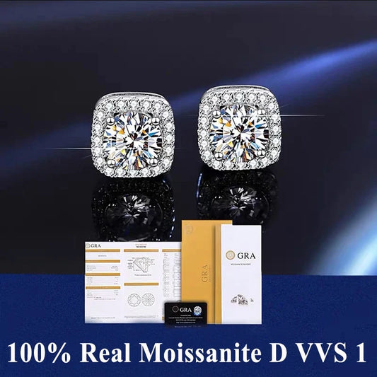 Pair of diamond earrings with certification on a dark background