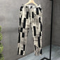 Patterned pants on a hanger against a gray background