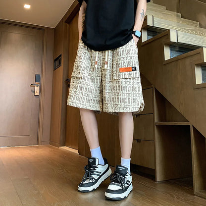 Person wearing a black top, patterned shorts, and black and white sneakers in a room with wooden flooring and furniture.