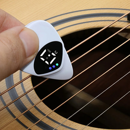 Digital guitar tuner held over a guitar string