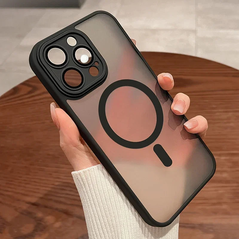 Phone case with a clear back and black border held by a person on a wooden surface.