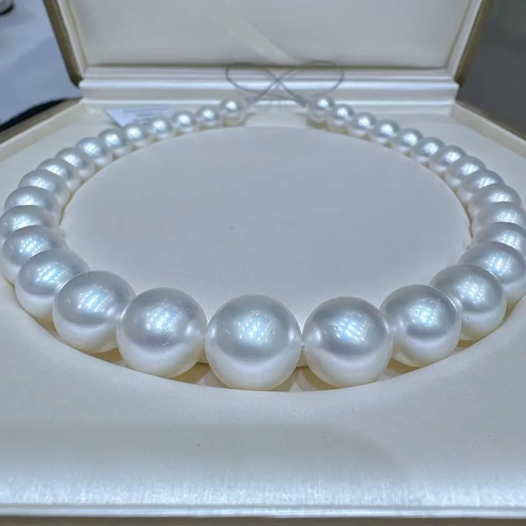 Pearl necklace on a white cushion in an open jewelry box