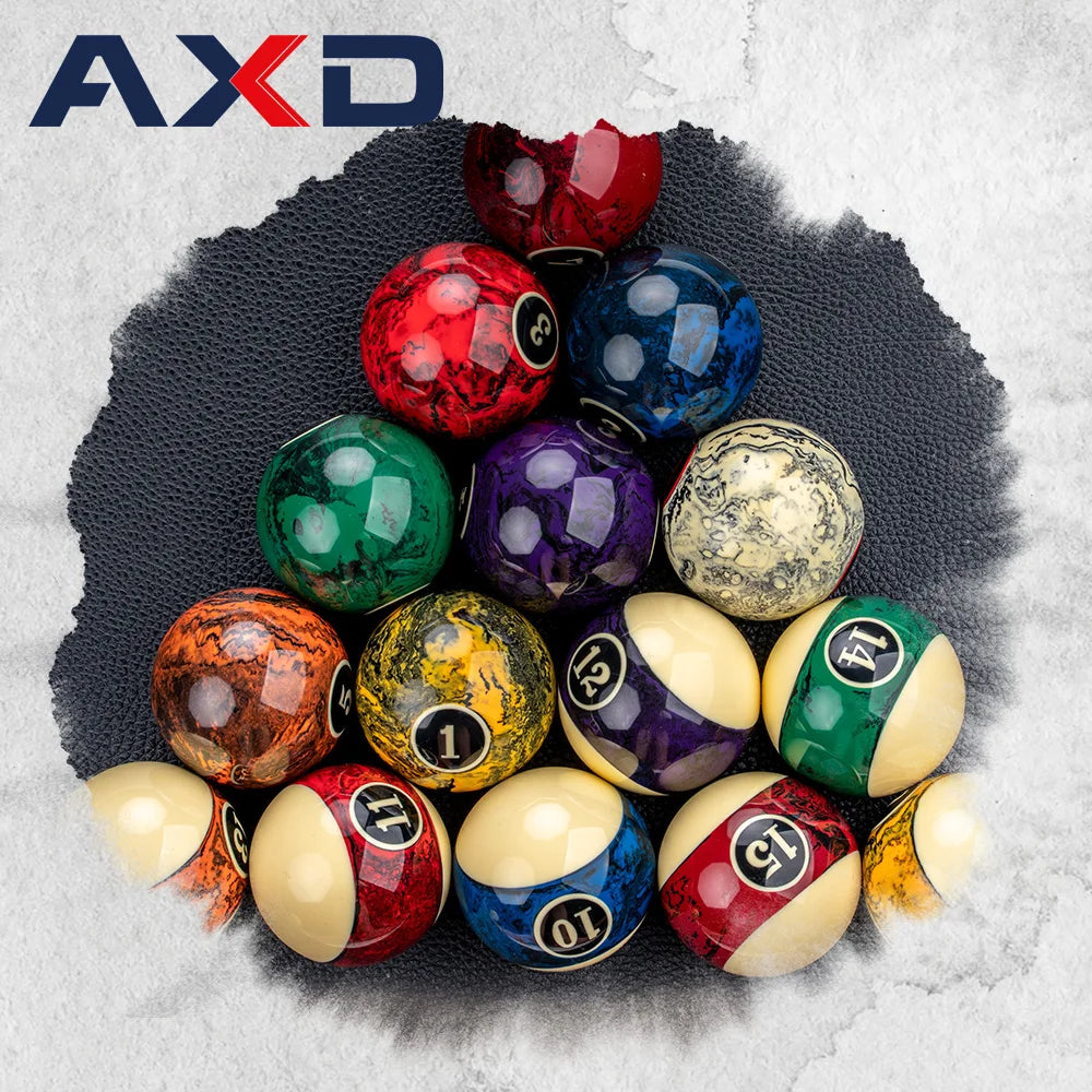 Assorted billiard balls with numbers on a textured black surface, featuring the AXD brand logo.