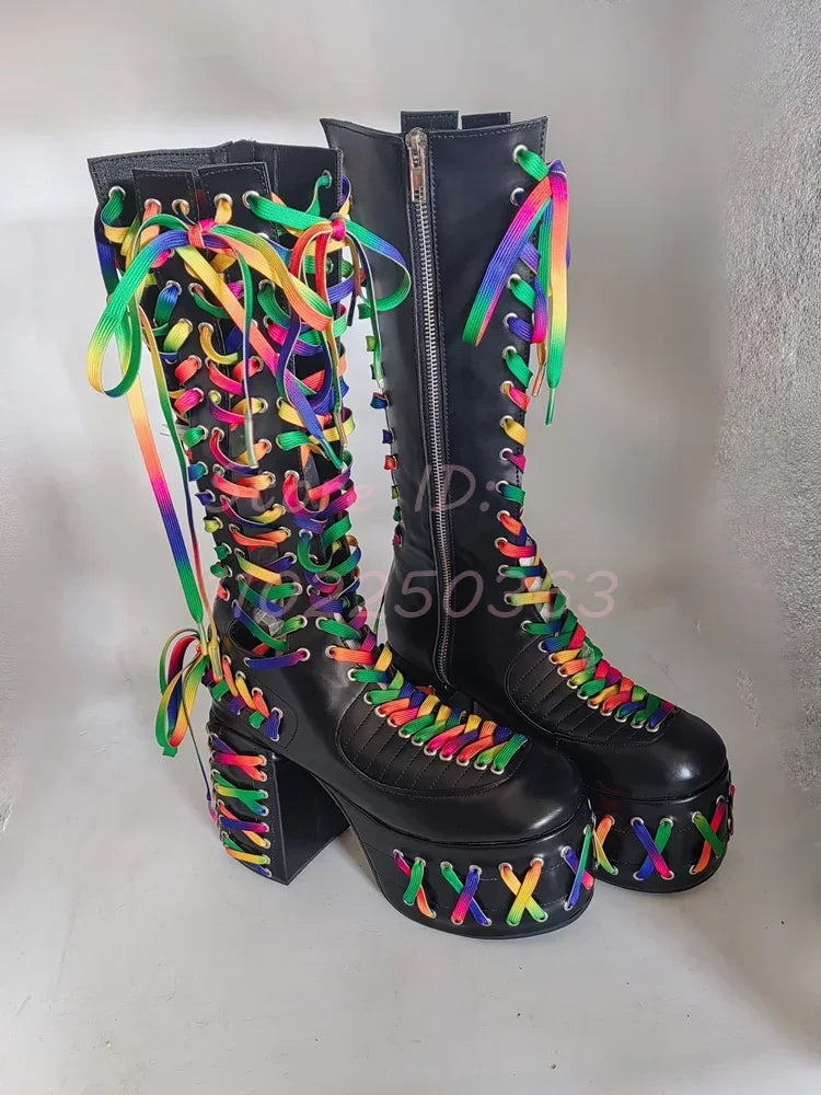 Black platform boots with colorful laces on a neutral background