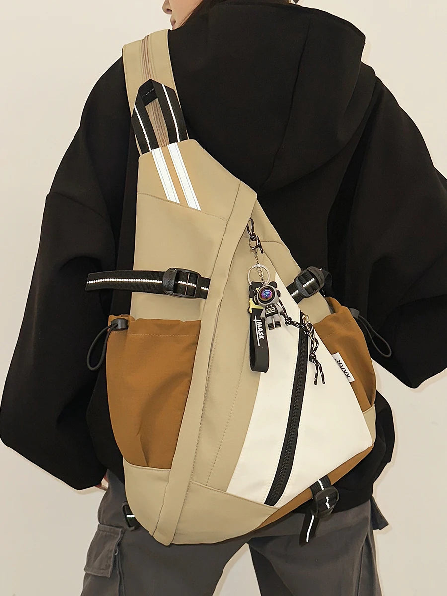 Person wearing a beige and brown backpack with a black jacket on a plain background