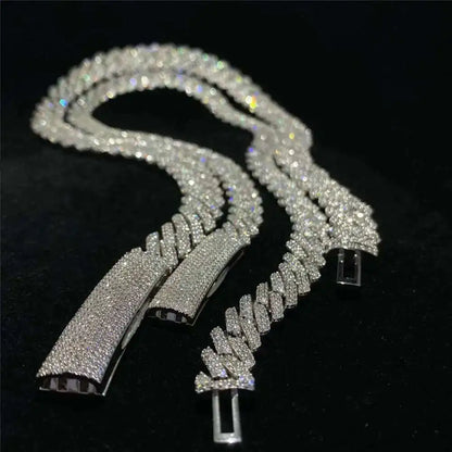 Silver chain necklace with diamond-like stones on a black background