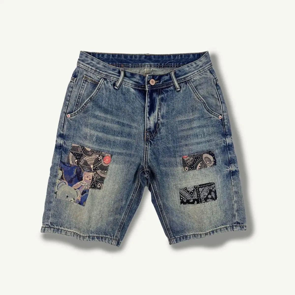 Blue denim shorts with patches on a white background