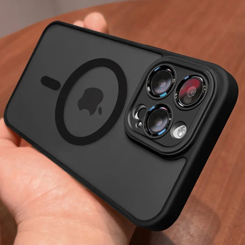 Black phone case with Apple logo held by a hand on a wooden surface