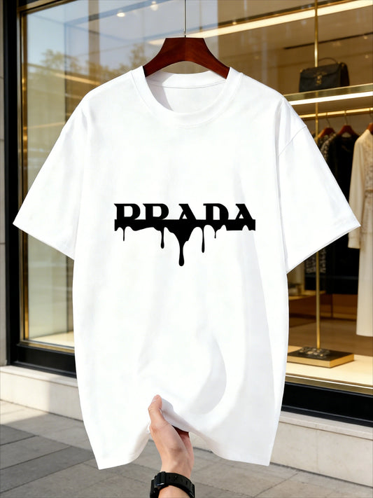 White t-shirt with black 'Prada' logo held in front of a store window.
