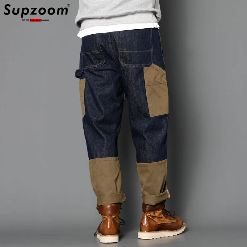 Patchwork pants worn by a person on a gray background with 'Supzoom' branding.