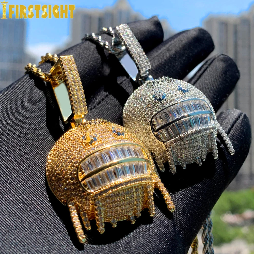 Gold and silver robot-shaped pendants on a black glove with blurred cityscape background