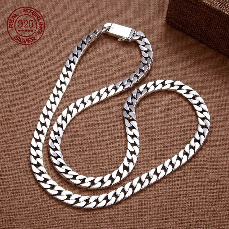 Silver chain necklace on a brown background with 'Real Sterling Silver' stamp.