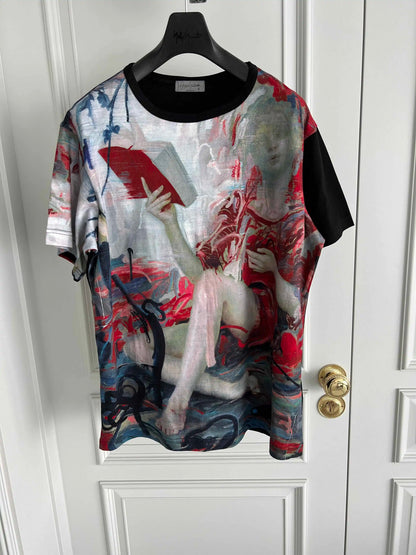 Artistic t-shirt with a graphic design on a hanger against a white door.