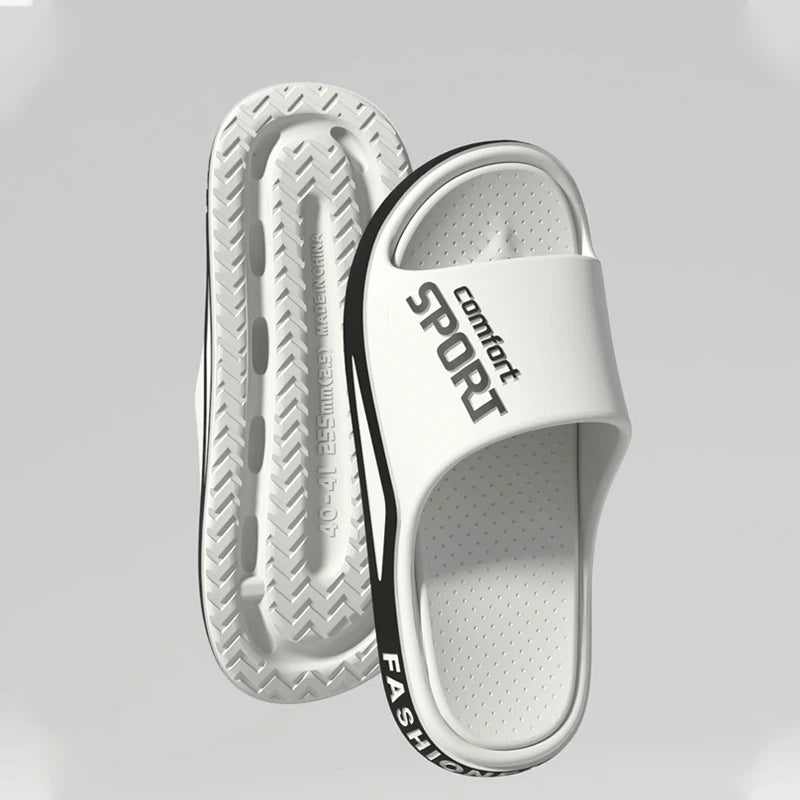 White slide sandals with 'Comfort Sport Fashion' text on a light gray background
