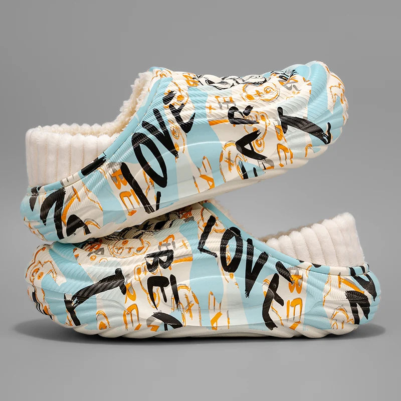 Pair of baby shoes with 'LOVE' and animal prints on a gray background