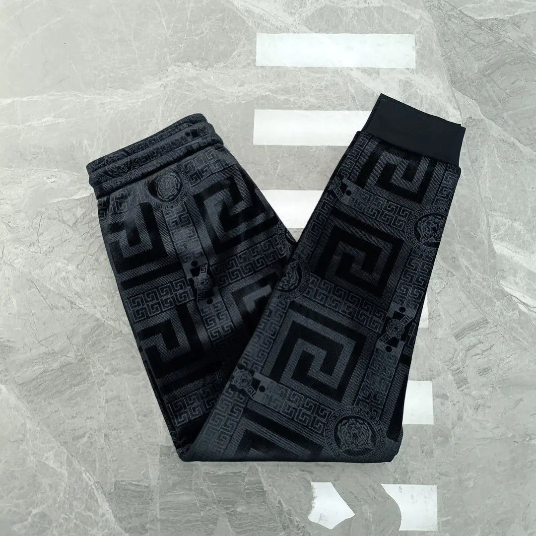 Black patterned belt on a textured gray background