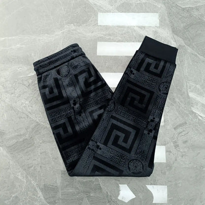 Black patterned belt on a textured gray background