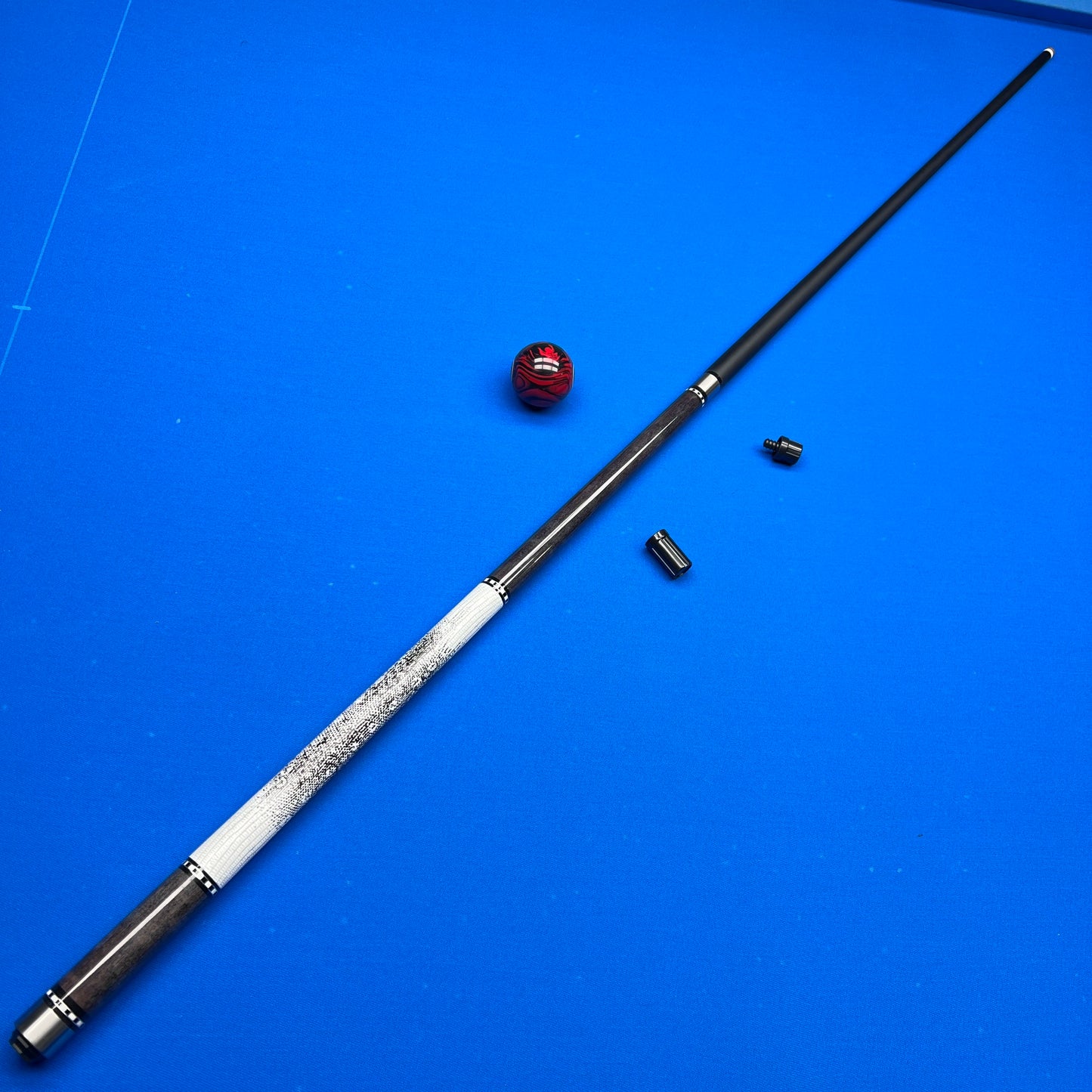 Pool cue with billiard balls on a blue felt surface