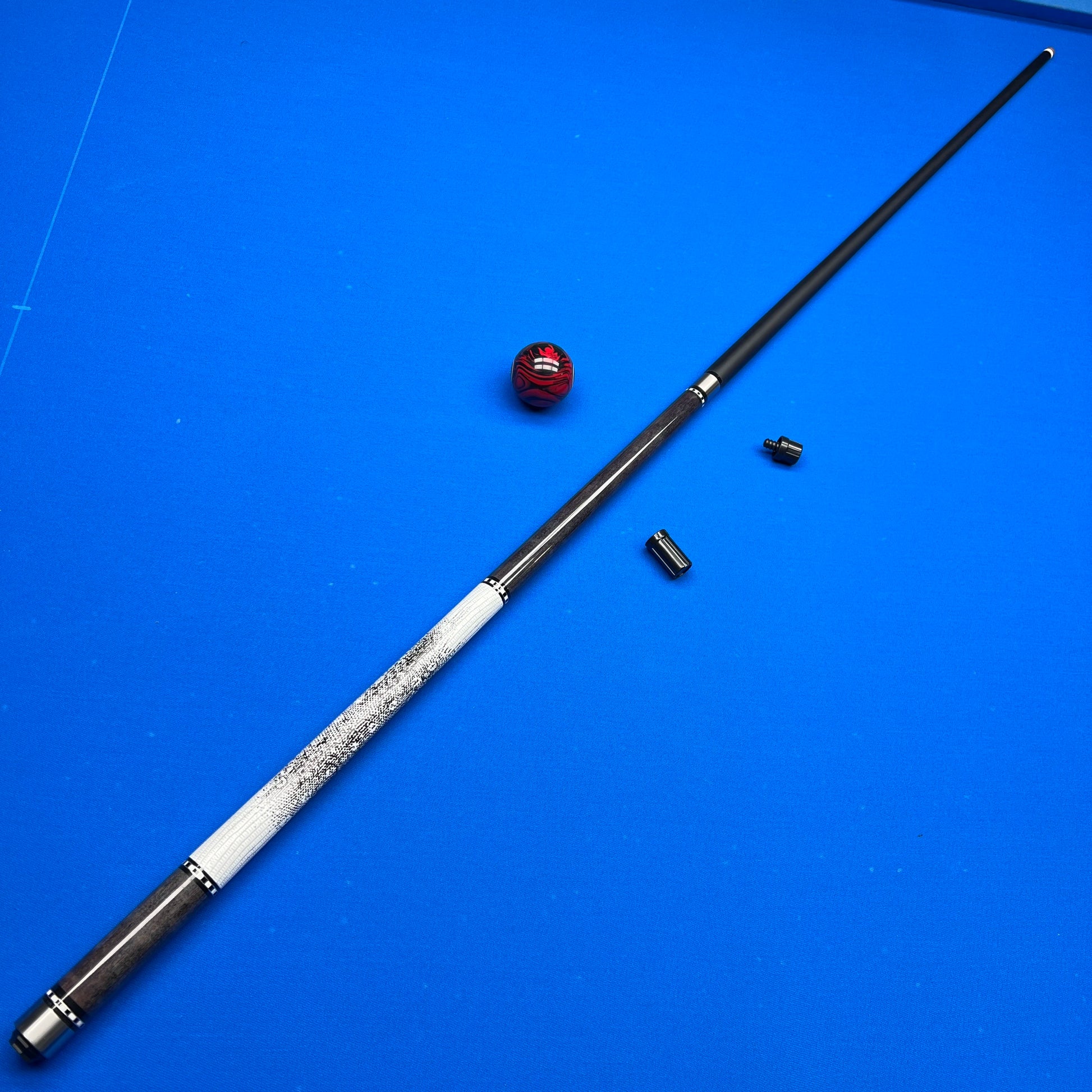 Pool cue with billiard balls on a blue felt surface
