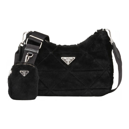 Black quilted handbag with matching pouch featuring Prada logo on a white background