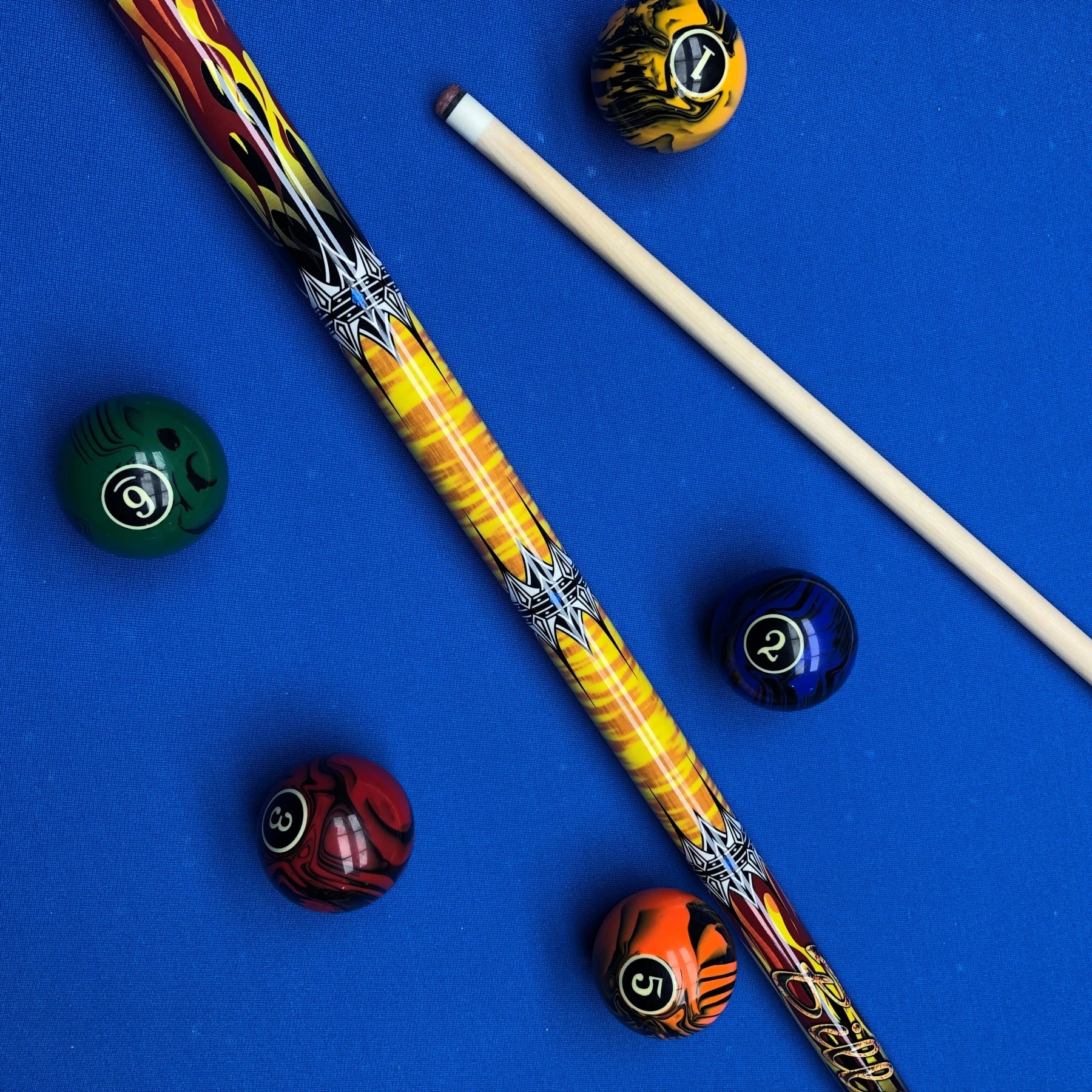 Colorful pool cue and balls on a blue background