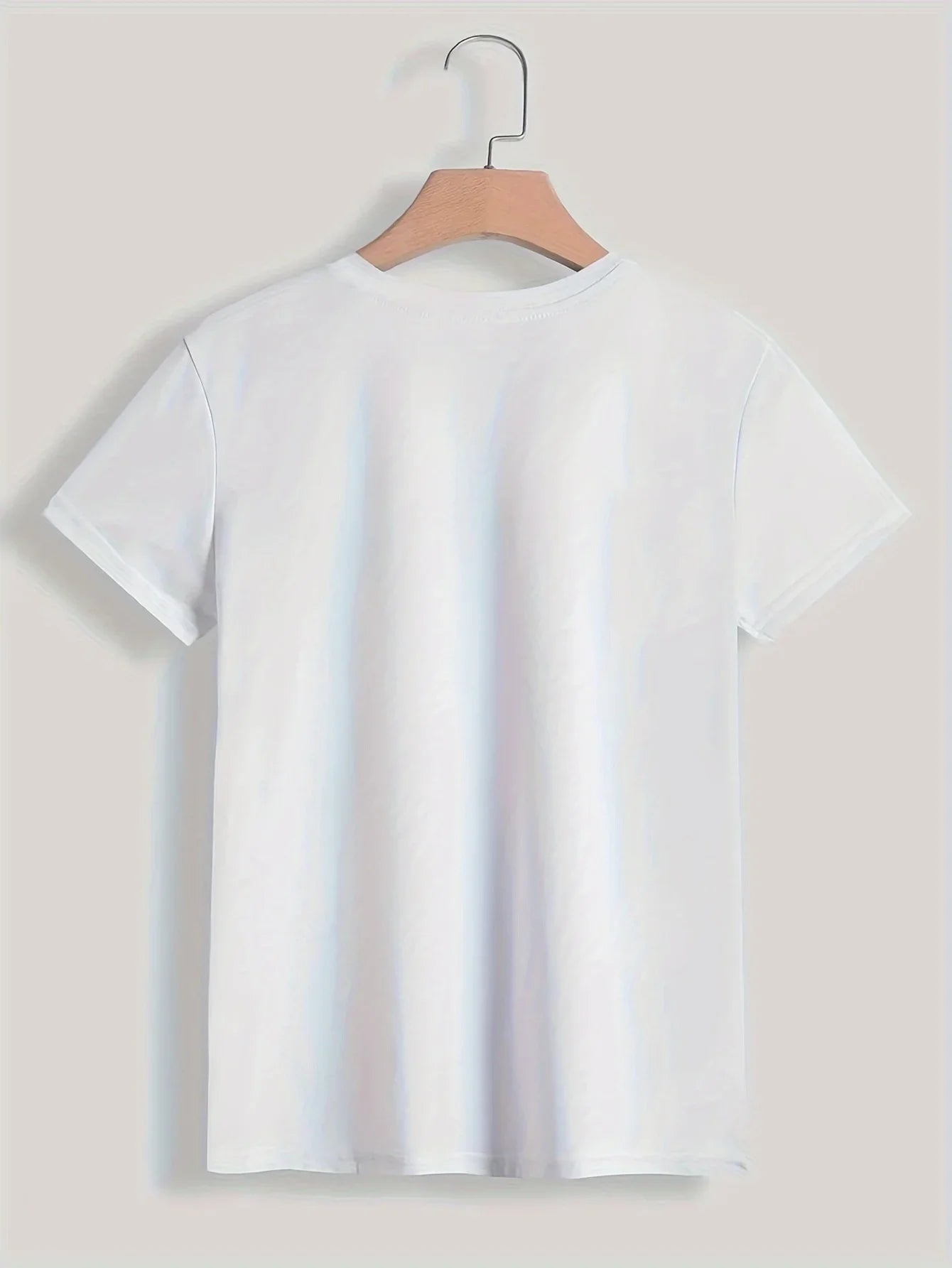 White t-shirt on a hanger against a light background