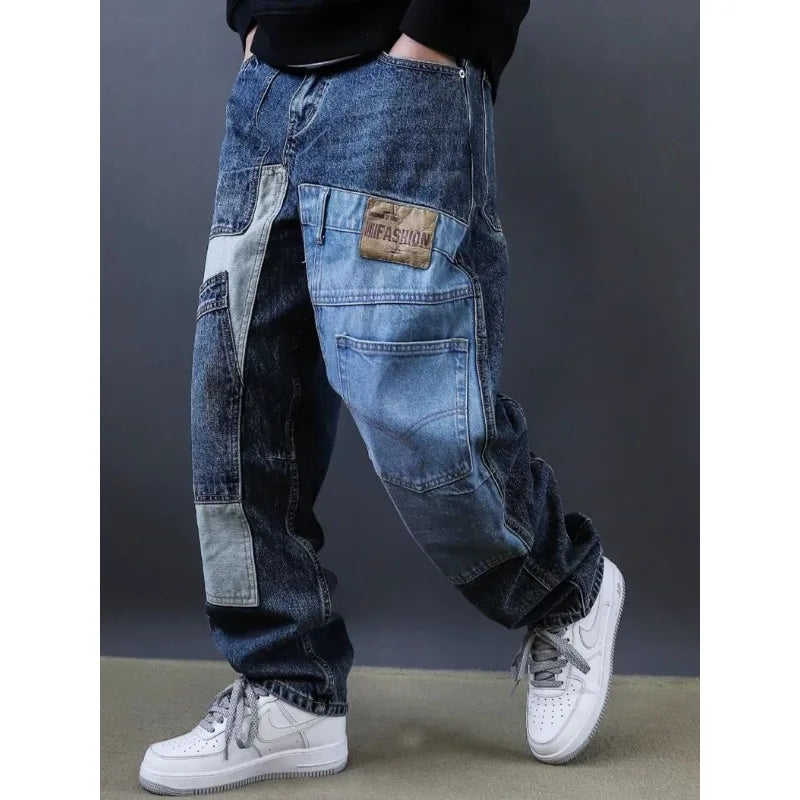 Blue patchwork jeans worn by a person with a dark background