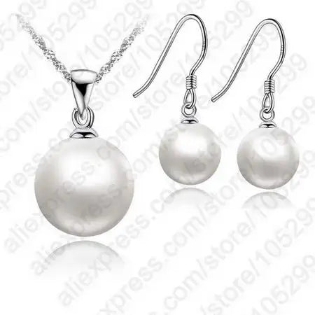Pearl necklace and earrings set on a white background