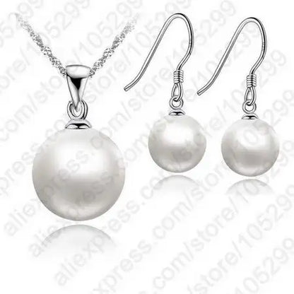 Pearl necklace and earrings set on a white background