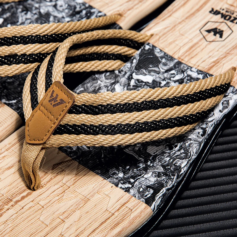 Close-up of a rope with a leather tag on a textured surface