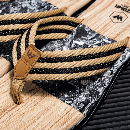 Close-up of a rope with a leather tag on a textured surface