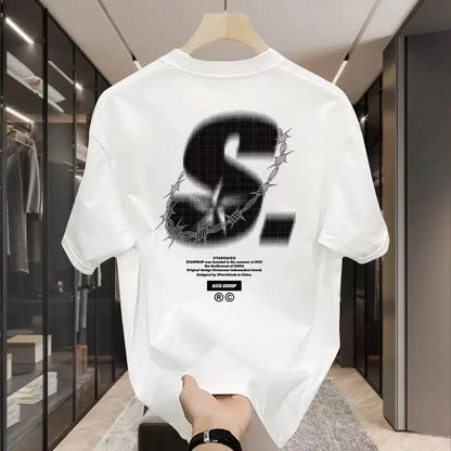 White t-shirt with black graphic design on a hanger in a store setting