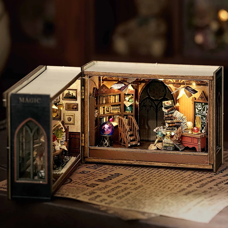 Miniature model of a magical book with interior scenes and objects on a dark background