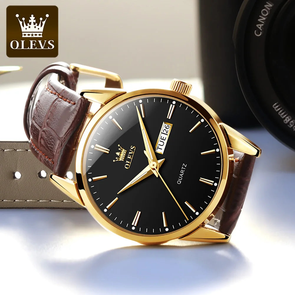 Gold watch with black dial and brown leather strap on a light surface, OLEVS brand visible.