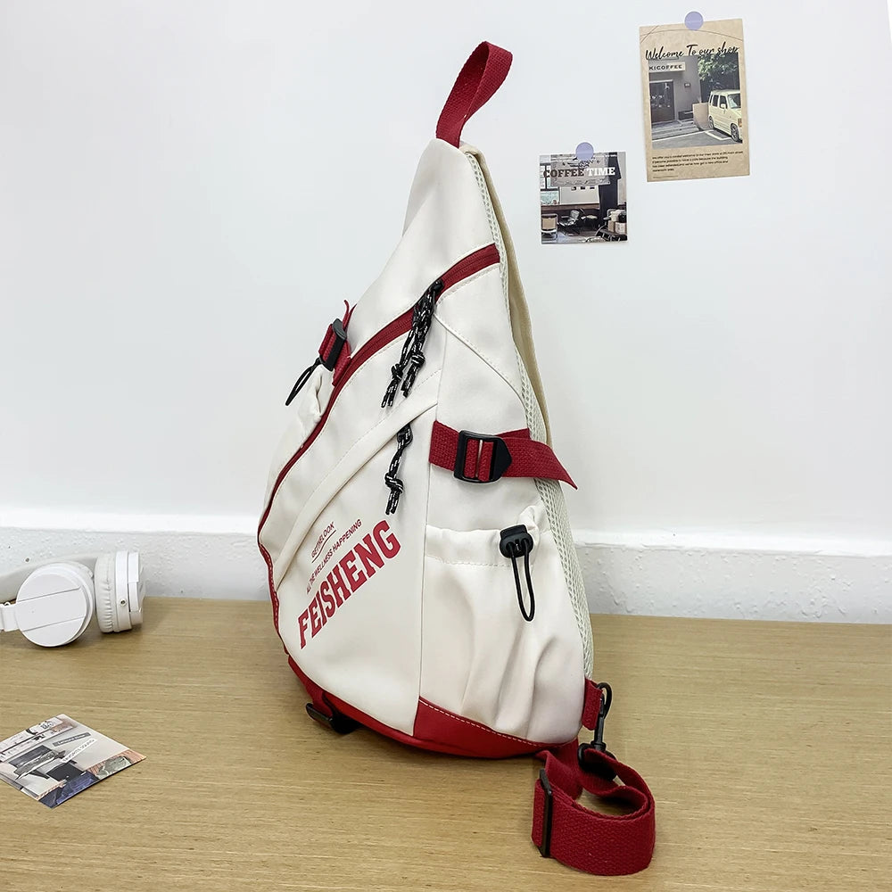 White and red sling bag with 'FEISHENG' branding on a wooden surface.