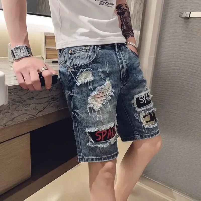 Person wearing ripped denim shorts with patches in a bathroom setting