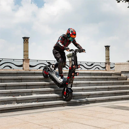 Person riding a scooter on stone steps with a scenic background