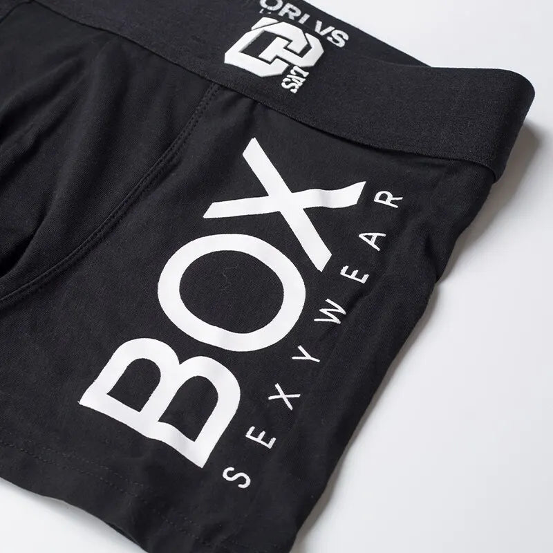 Black boxer briefs with 'Box Sexy Wear' branding on a white background