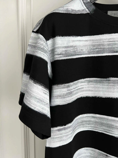 Black and white striped sweater against a plain background