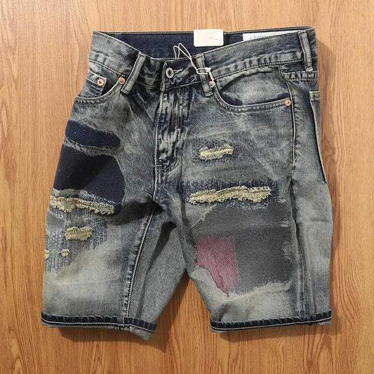 Distressed denim shorts on a wooden surface