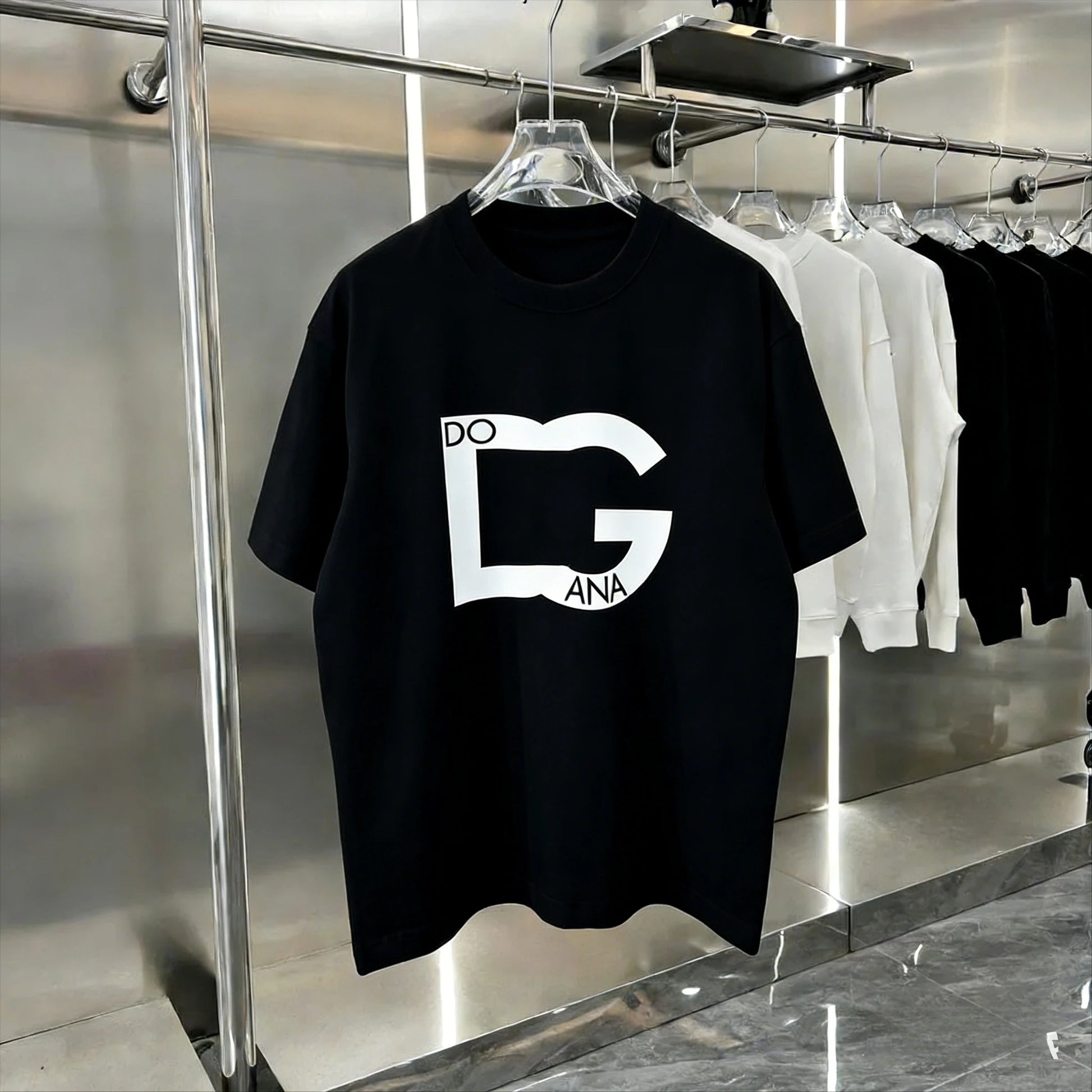 Black t-shirt with a white logo on a hanger in a store setting